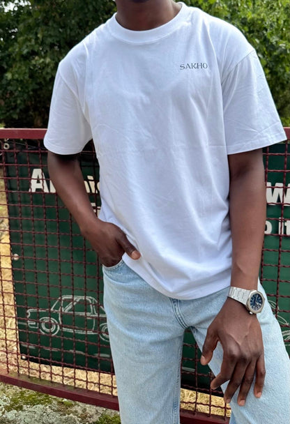 Model wearing the white SAKHO Quiet Strength Tee, front view